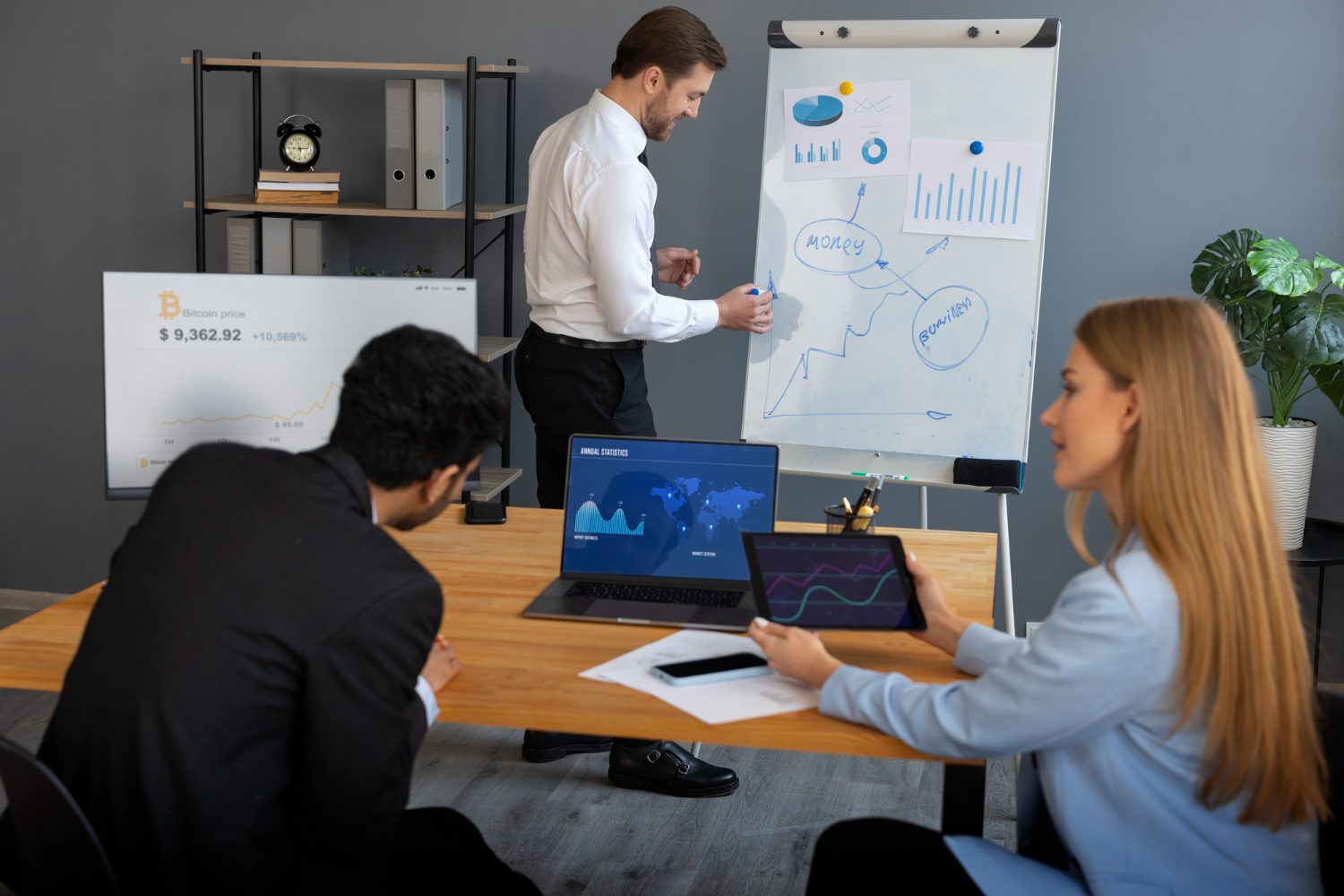 A group of business people sitting around a table in an office.